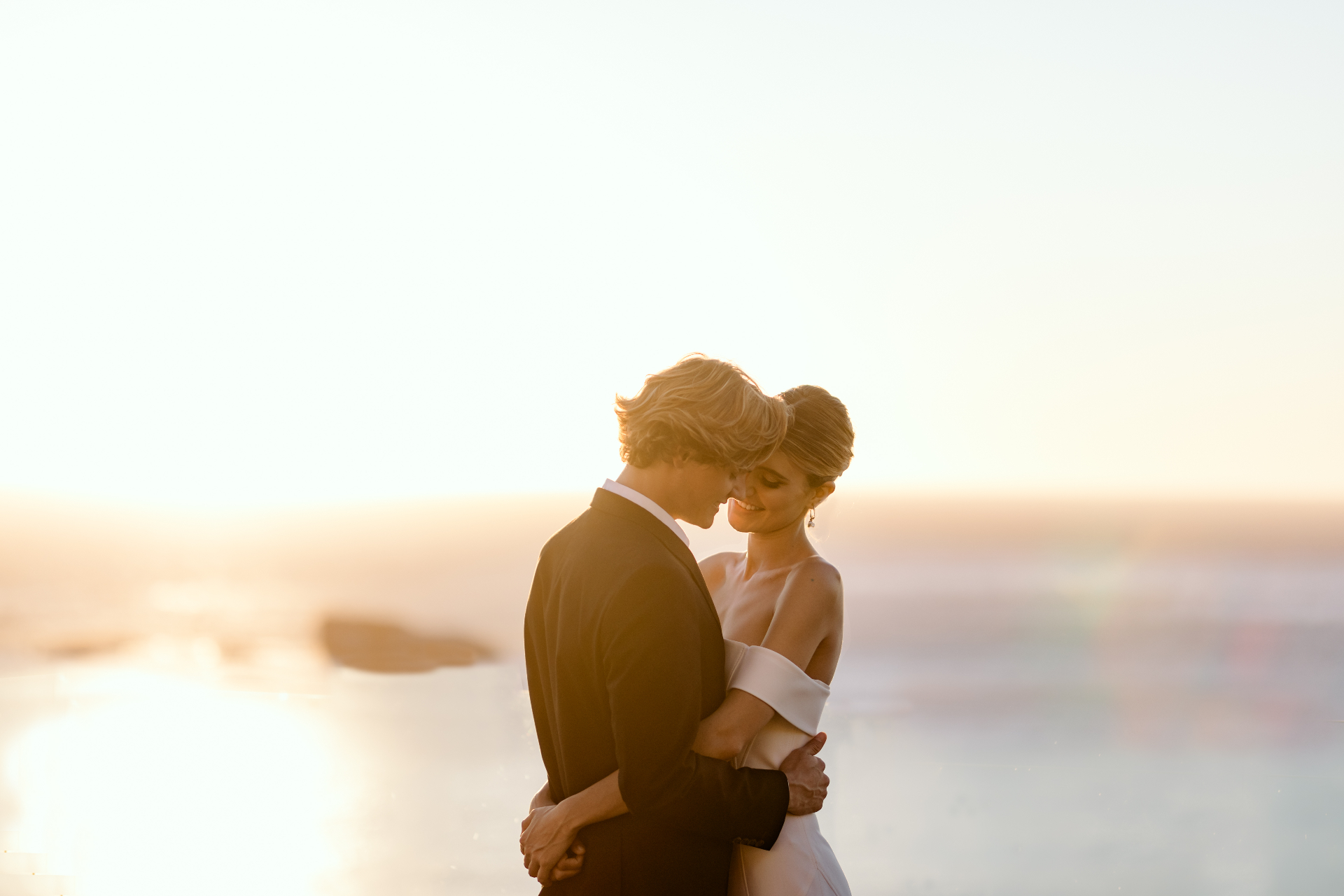Couple embracing at sunset by the sea